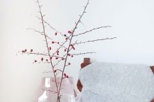 a stylish pink and copper vase with branches with berries is a cool fall Nordic decoration