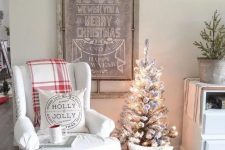 a vintage Christmas sign topped with a snowy evergreen garland is ideal for a farmhouse Christmas space