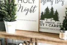 a whole arrangement of Christmas signs and prints in stained wooden frames is a lovely idea for a rustic space