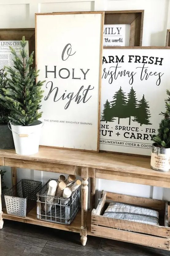a whole arrangement of Christmas signs and prints in stained wooden frames is a lovely idea for a rustic space