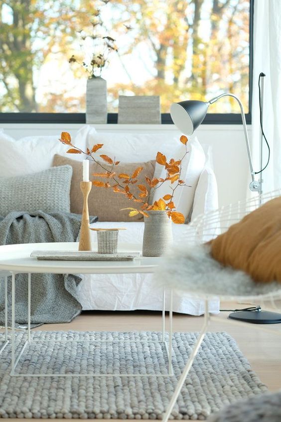 airy Scandinavian fall decor with bright leaves, candles and some vases is a cool solution for the fall