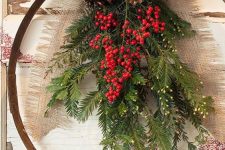 an all-natural holiday wreath with evergreens, berries, pinecones and a burlap ribbon bow is a lovely idea for a rustic space