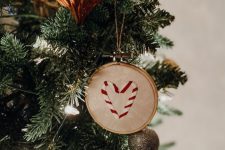 an embroidery hoop Christmas tree ornament with candy canes embroidered is a very cool idea