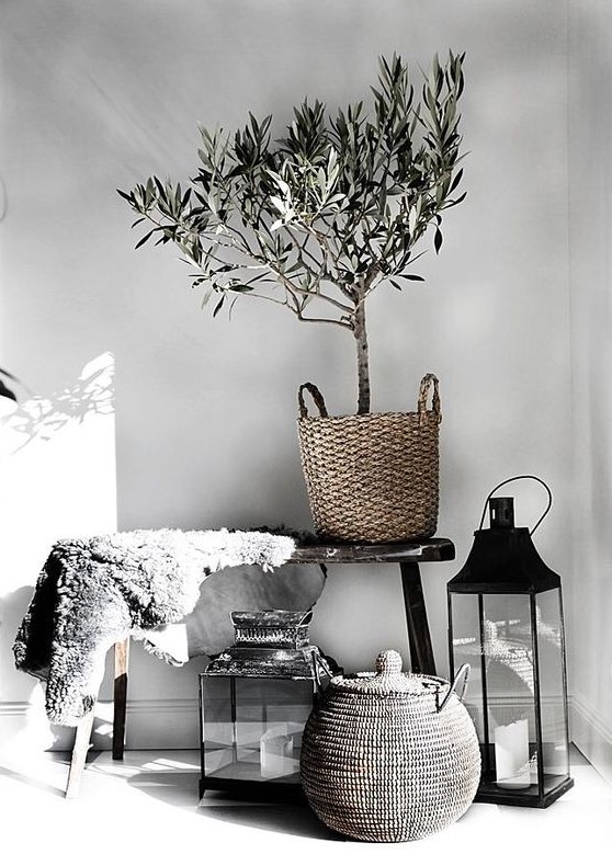 baskets, candles, a faux fur piece add a natural feel to the Nordic space and keep the monochromy up