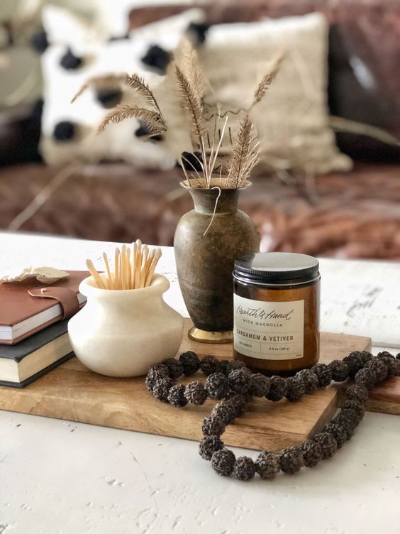 chic Scandinavian fall decor with matches, a candle in a jar and a nut garland, some dried grasses