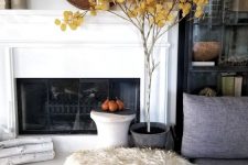 cozy fall decor with a fall tree in a planter, pears on a plate, a decorative basket and some husks