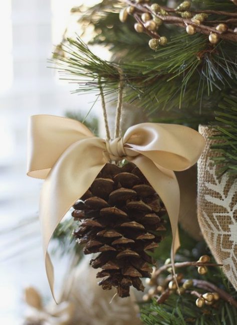 elegant rustic Christmas ornaments of pinecones and silk bows on top is a traditional Christmas decoration