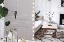 simple fall Scandinavian decor with nuts in a plate, white pumpkins and candle lanterns is a cool solution