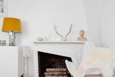white faux fur covers and rugs, antlers, pebbles and firewood make this space Nordic yet fall-like