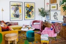 06 a bold maximalist living room with a mustard sectional, pink chairs, an emerald pouf, a bold gallery wall and a bright rug plus statement plants