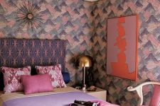 11 a lovely maximalist bedroom with brushstroke walls, a printed bed, pastel bedding, a pink chair, a gold sculptural chandelier