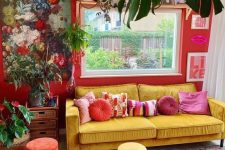 13 a bold maximalist living room with red walls, a yellow sofa and colorful stools, bold rugs, lovely artworks and potted plants