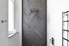 15 a chic contemporary shower space with white walls and an accent graphite grey skinny tiles clad in a chevron pattern and extended to the floor