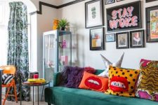 15 a colorful maximalist living space with a green sofa, an orange ottoman, a bold gallery wall and colorful pillows