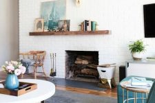 32 a modern farmhouse living room with white brick walls and touches of turquoise and teal