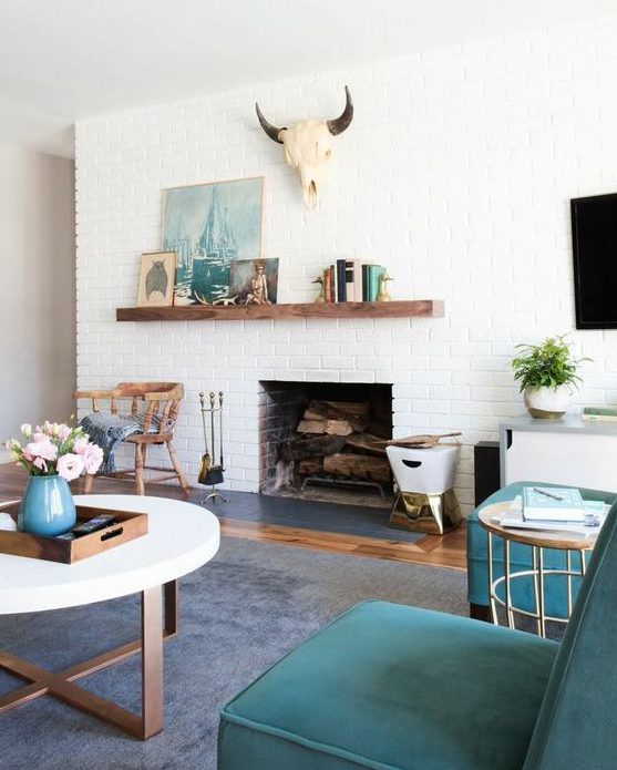 a modern farmhouse living room with white brick walls and touches of turquoise and teal