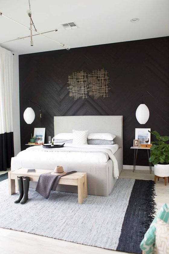 refined black wood accent wall with an artwork, brass touches and black and white decor