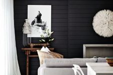 36 a Scandinavian living room with a black shiplap accent wall that makes a statement in this neutral space
