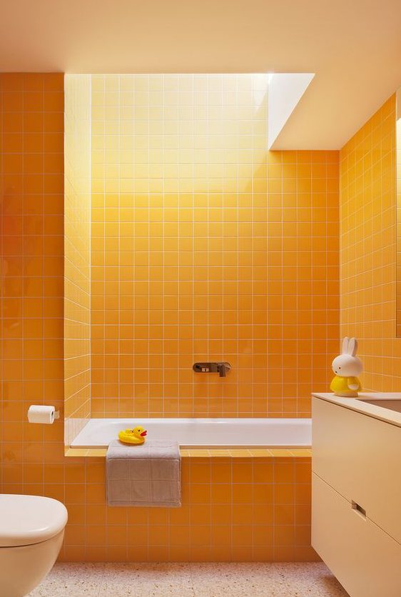 a bright bathroom done in sunny yellow, with touches of white and a skylight to create a mood