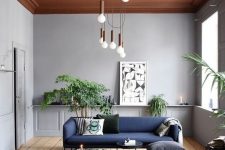 38 a statement modern chandelier featuring multiple bulbs with copper touches