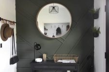 39 a modern entryway done in neutrals and with a black paneled wall plus some dark furniture for a very chic and cool look