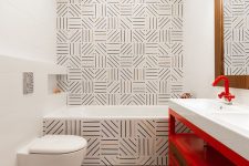 41 unique graphic tiles, a red vanity and red fixtures are a cool combo for a bold and catchy bathroom