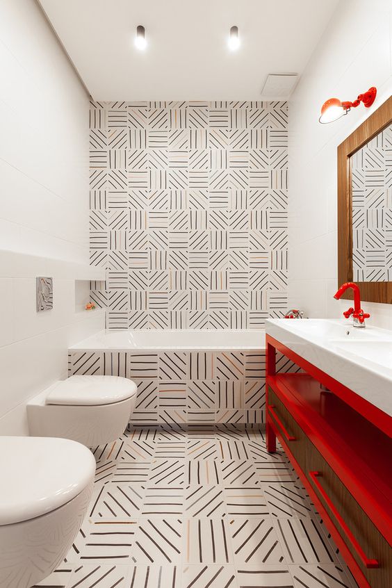 unique graphic tiles, a red vanity and red fixtures are a cool combo for a bold and catchy bathroom