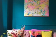 43 a bright teal living room with a hot pink sofa and colorful pillows, bright dried grasses and blooms are really about dopamine