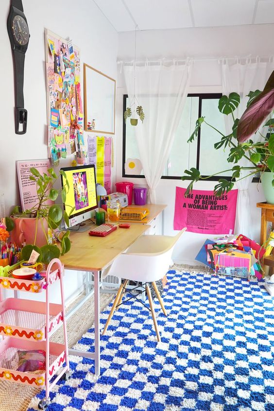 a colorful home office with a neutral desk and chair, colorful textiles, decor and other furniture