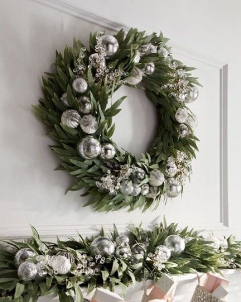 a beautiful greenery wreath with silver ornaments and beads is a lovely holiday decor idea you can steal