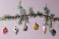 a branch with whimsical Christmas ornaments is a lovely and unusual decoration for the holidays