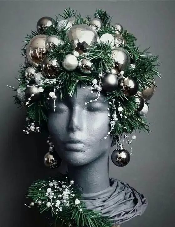a bust decorated with evergreens, snowy pieces and silver ornaments as a headpiece and earrings is a unique idea for Christmas