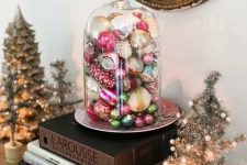 a cloche with vintage Christmas ornaments is a lovely decoration or display for the holidays