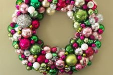 a colorful Christmas wreath of ornaments of green, pink, silver, blush balls and snowflakes