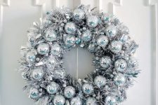 a fantastic disco ball and silver tinsel Christmas wreath is a very eye-catchy and cool idea