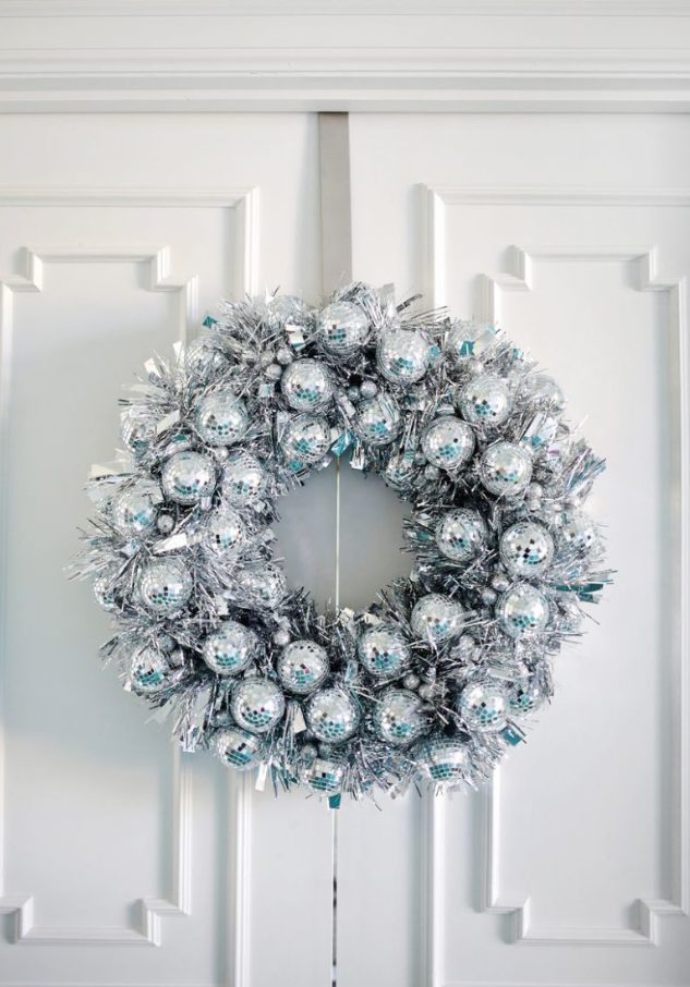 a fantastic disco ball and silver tinsel Christmas wreath is a very eye-catchy and cool idea