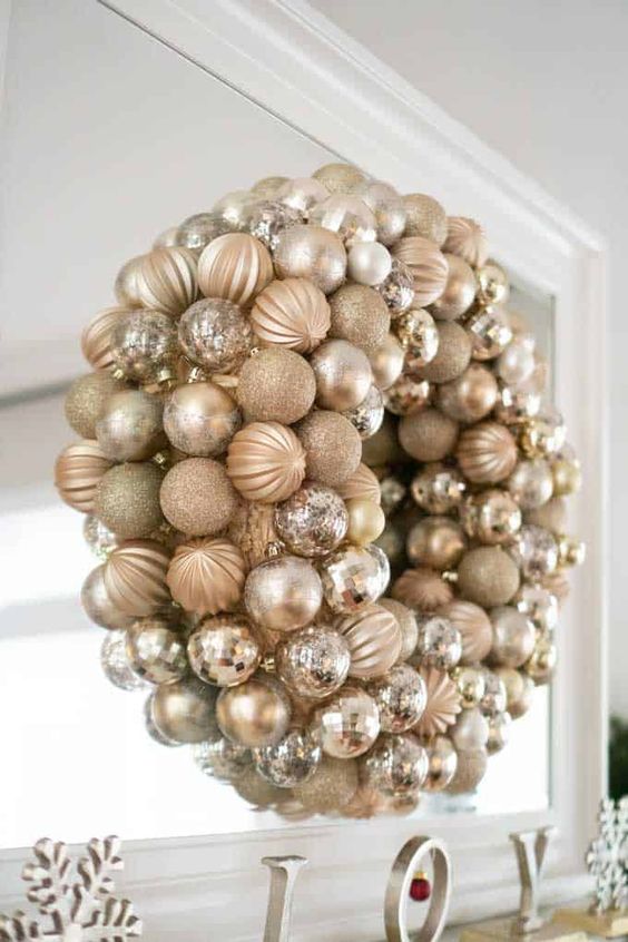 a glam gold Christmas wreath composed of ornaments is a super cool and catchy decoration