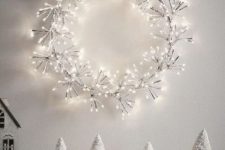 a light Christmas wreath imitating snowflakes is a lovely decoration to rock during the holidays