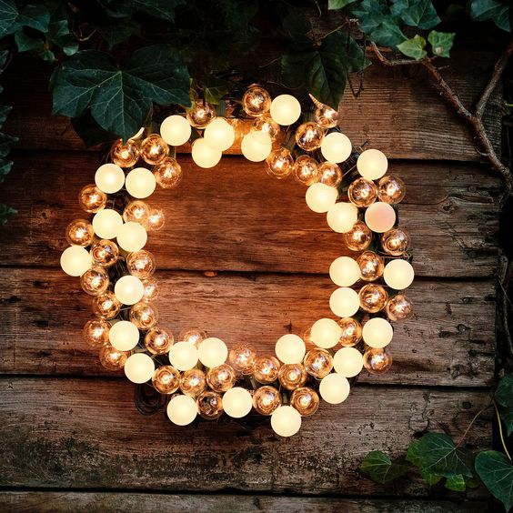 a light Christmas wreath with clear and matte bulbs is a cool and catchy decoration for the holidays