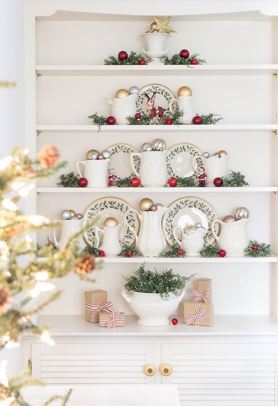 a lovely Christmassy jug and ornament display on the shelves with greenery is cool for a kitchen or dining room