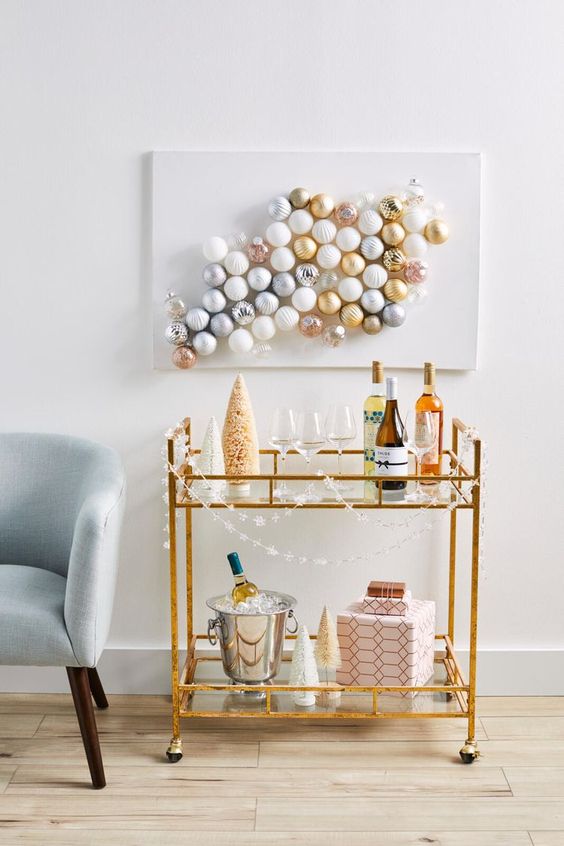 a lovely modern Christmas artwork of white, gold, pink and grey ornaments is a very fresh way to style your space for the holidays