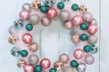 a lovely pink tinsel Christmas wreath with pink, blush, gold, silver and green ornaments is a cool out of the box idea