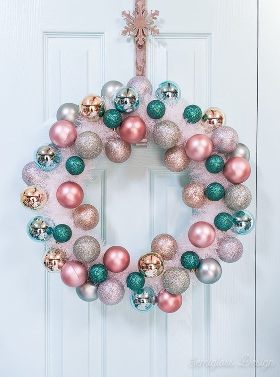 a lovely pink tinsel Christmas wreath with pink, blush, gold, silver and green ornaments is a cool out of the box idea