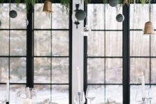 a modern overhead Christmas installation of evergreens, grey and clear baubles and bells is awesome
