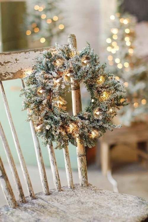 a small flocked Christmas wreath decorated with lights is a cool decor idea for the holidays