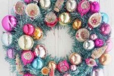 a snowy tinsel Christmas wreath with colorful vintage ornaments is a super cool and catchy idea