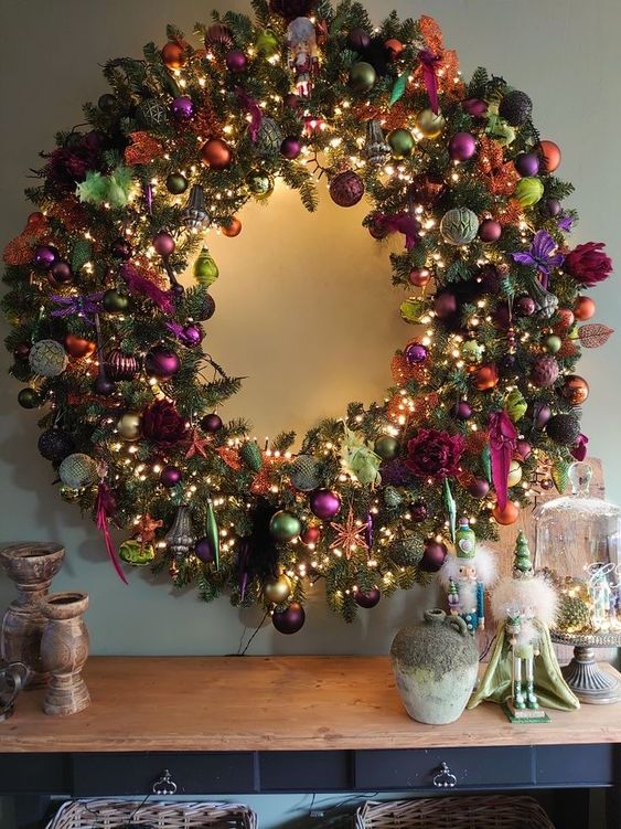 a super bold holiday wreath of evergreens and all kinds of colorful ornaments and lights plus ribbons is wow