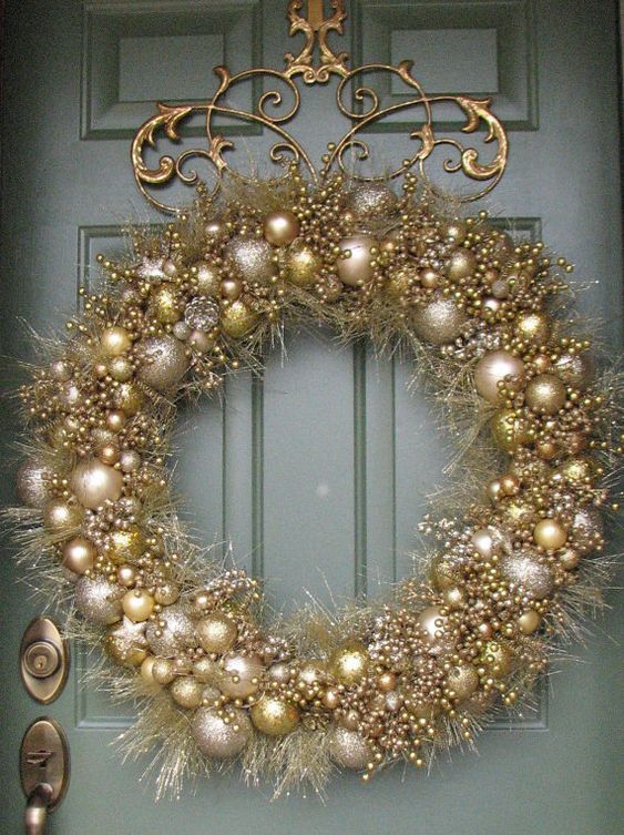 a super glam and shiny christmas wreath composed of silver and gold glitter ornaments and matching tinsel will shine bright