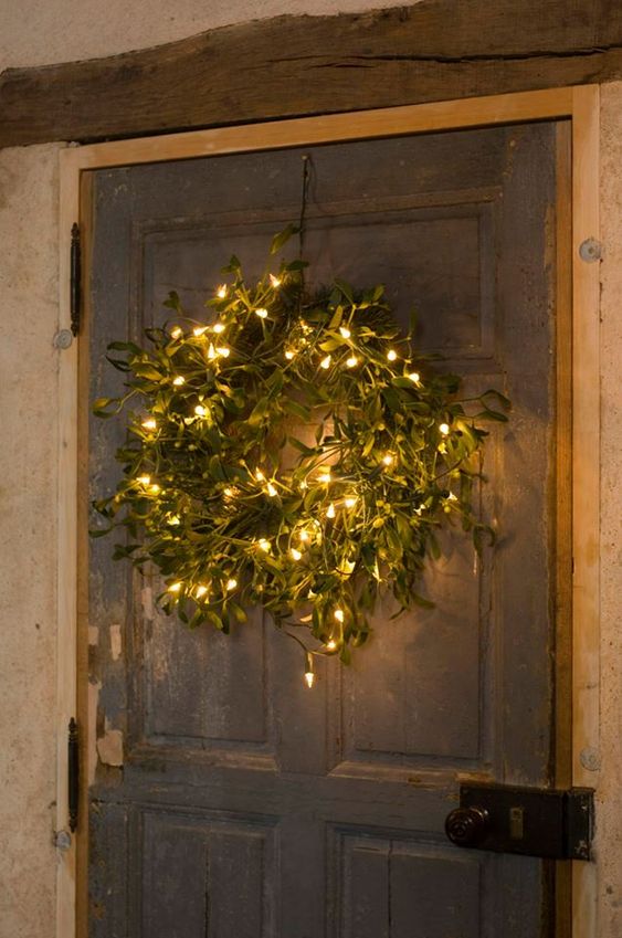 a textured greenery Christmas wreath with lights is a stylish modern farmhouse decoration for the holidays