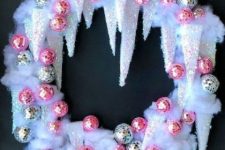 a unique icicle Christmas wreath with silver and pink disco balls is a super catchy decor idea